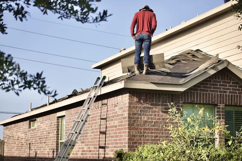 Professional roofer working on a residential roof in Sikeston